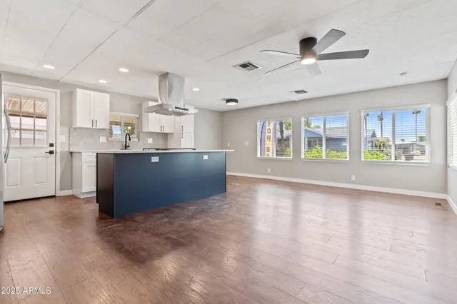 a view of kitchen with refrigerator and window