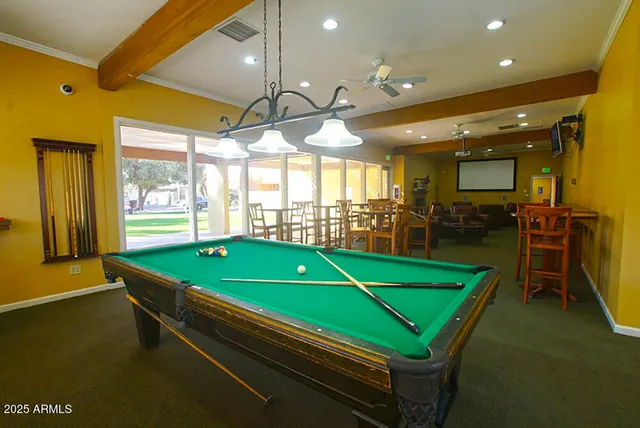 a room with pool table and windows