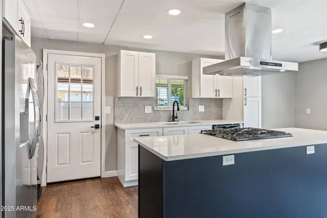 a kitchen with stainless steel appliances granite countertop a sink stove and refrigerator