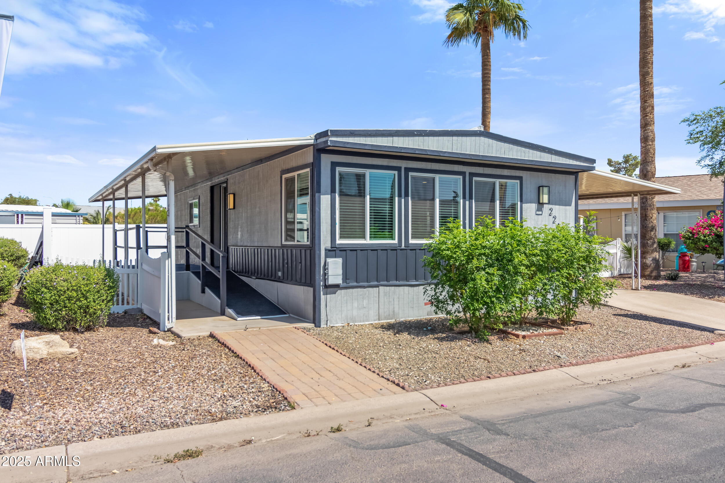 2401 West Southern Avenue, Unit 224 Tempe, AZ 85282 - Photo 6 of 47 a front view of a house with a garden
