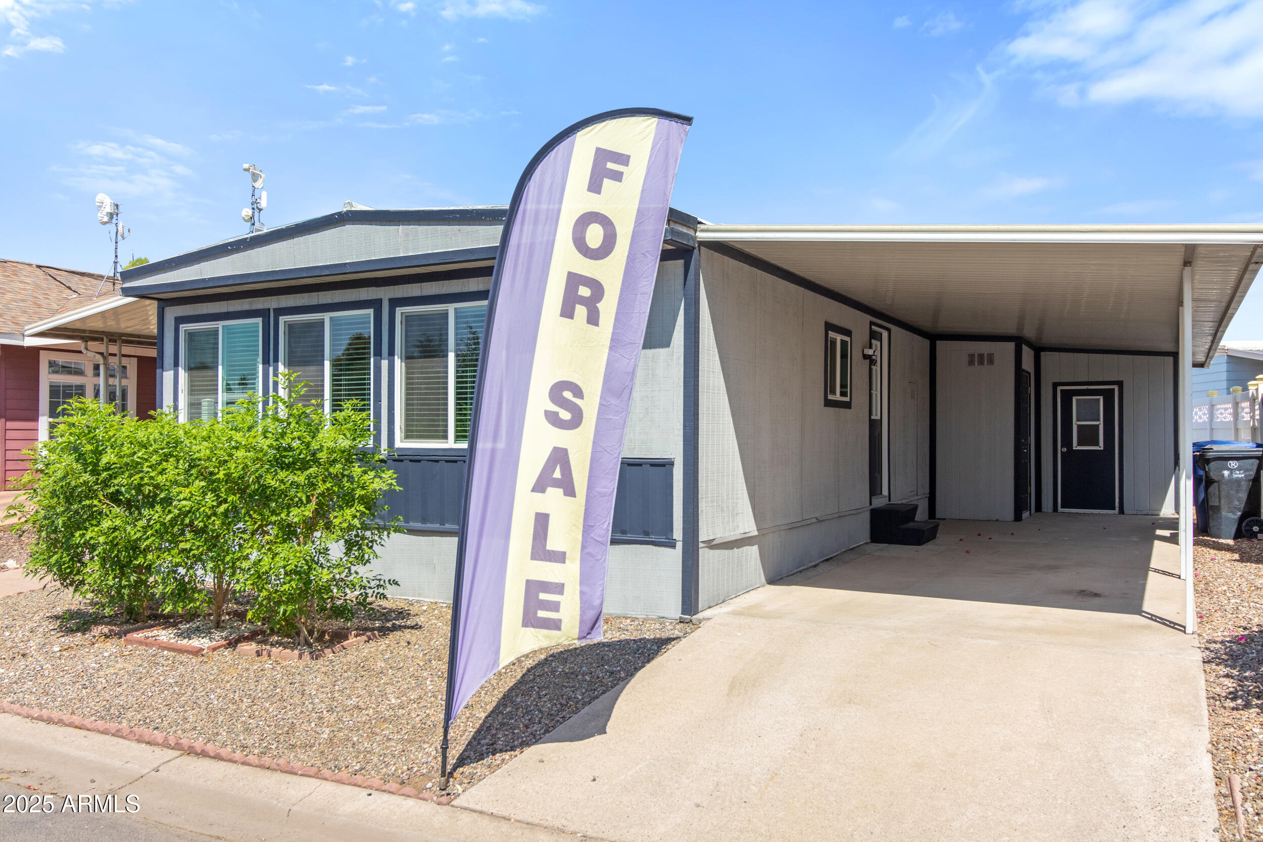 2401 West Southern Avenue, Unit 224 Tempe, AZ 85282 - Photo 7 of 47 a front view of a house with a garden