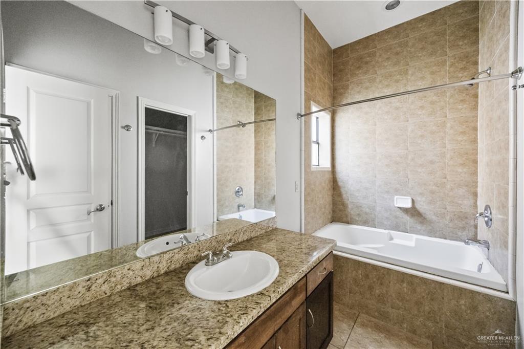2715 Mimosa Street, Unit 2 Mission, TX 78574 - Photo 11 of 13 a bathroom with a granite countertop sink and a mirror