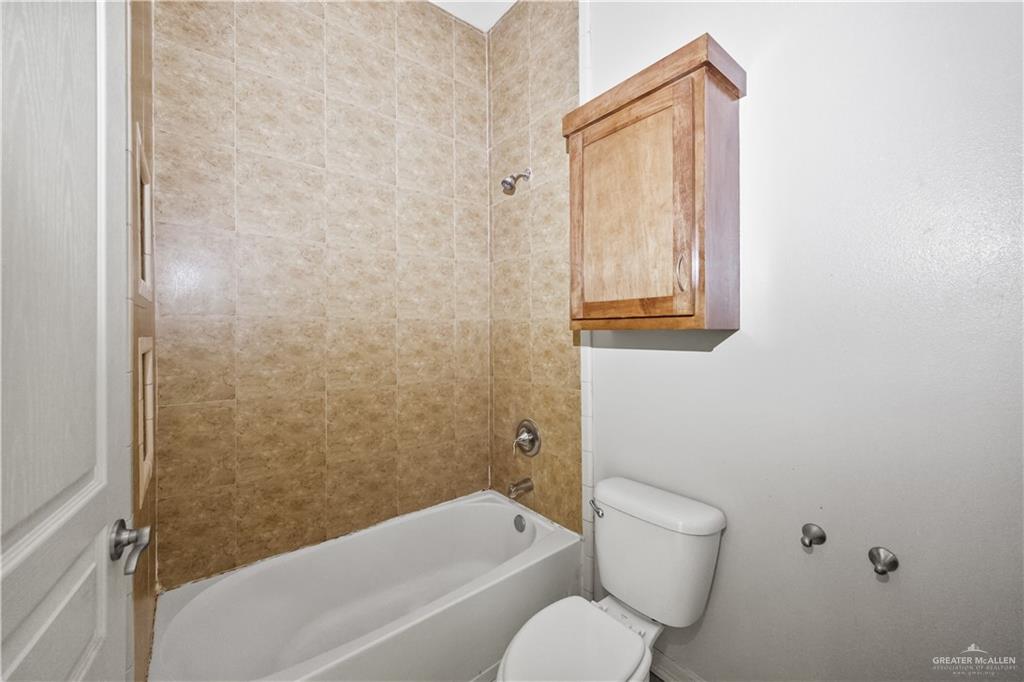 2715 Mimosa Street, Unit 2 Mission, TX 78574 - Photo 9 of 13 a bathroom with a toilet and a bathtub