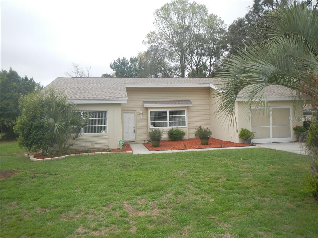 1543 Bishop Road Spring Hill, FL 34608 - Photo 1 of 1 front view of a house with a yard