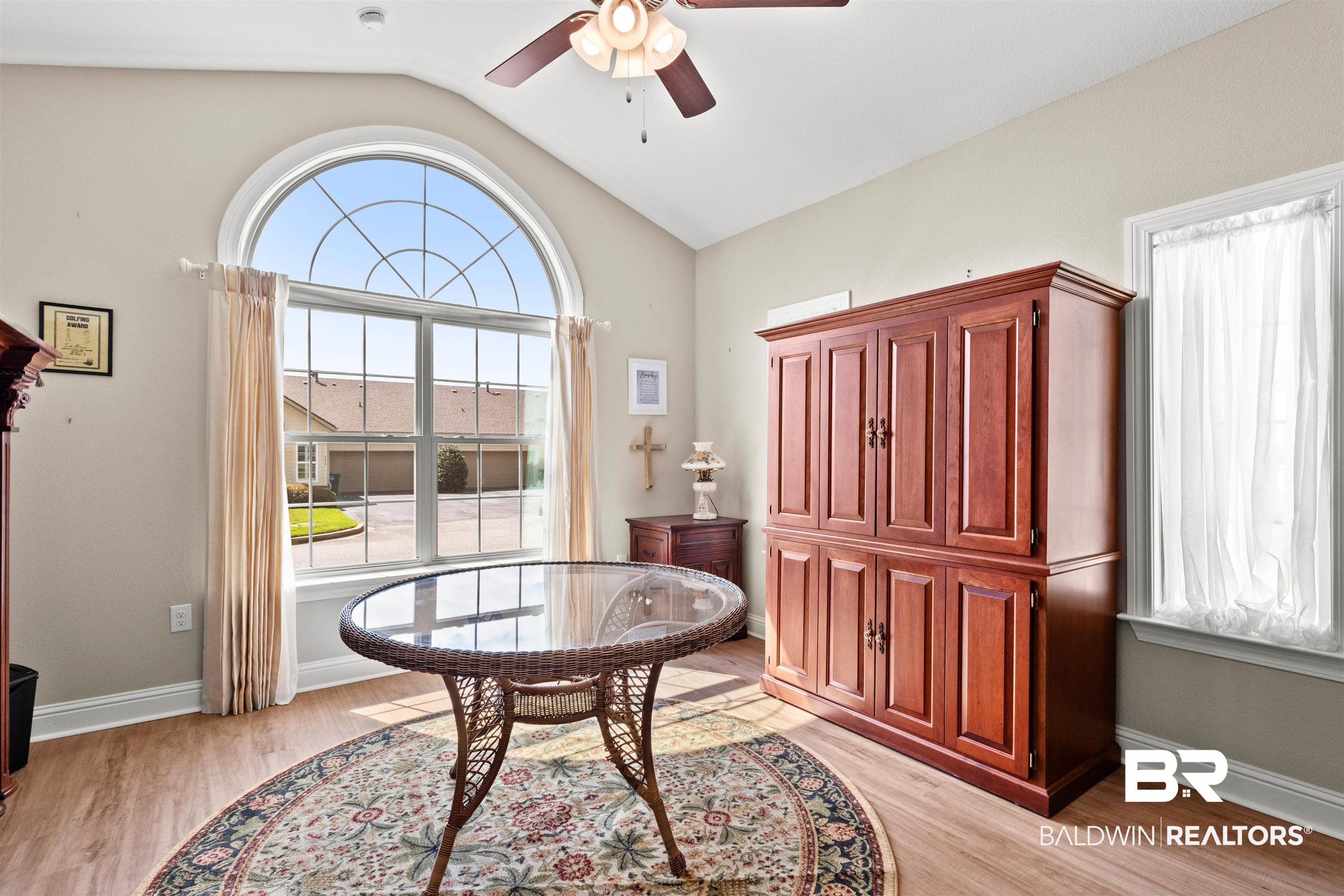 301 Holmes Avenue, Unit 301 Foley, AL 36535 - Photo 33 of 54 Living area with baseboards, lofted ceiling, light wood-style flooring, and a ceiling fan