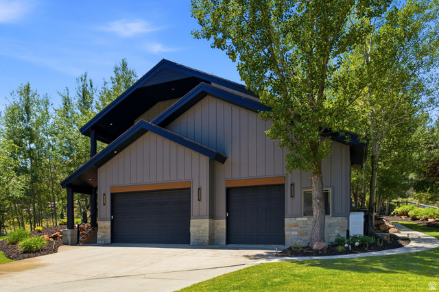 3027 Homestead Road Park City, UT 84098 - Photo 53 of 62 Modern exterior with vertical board siding, stone accents, and two garage bays