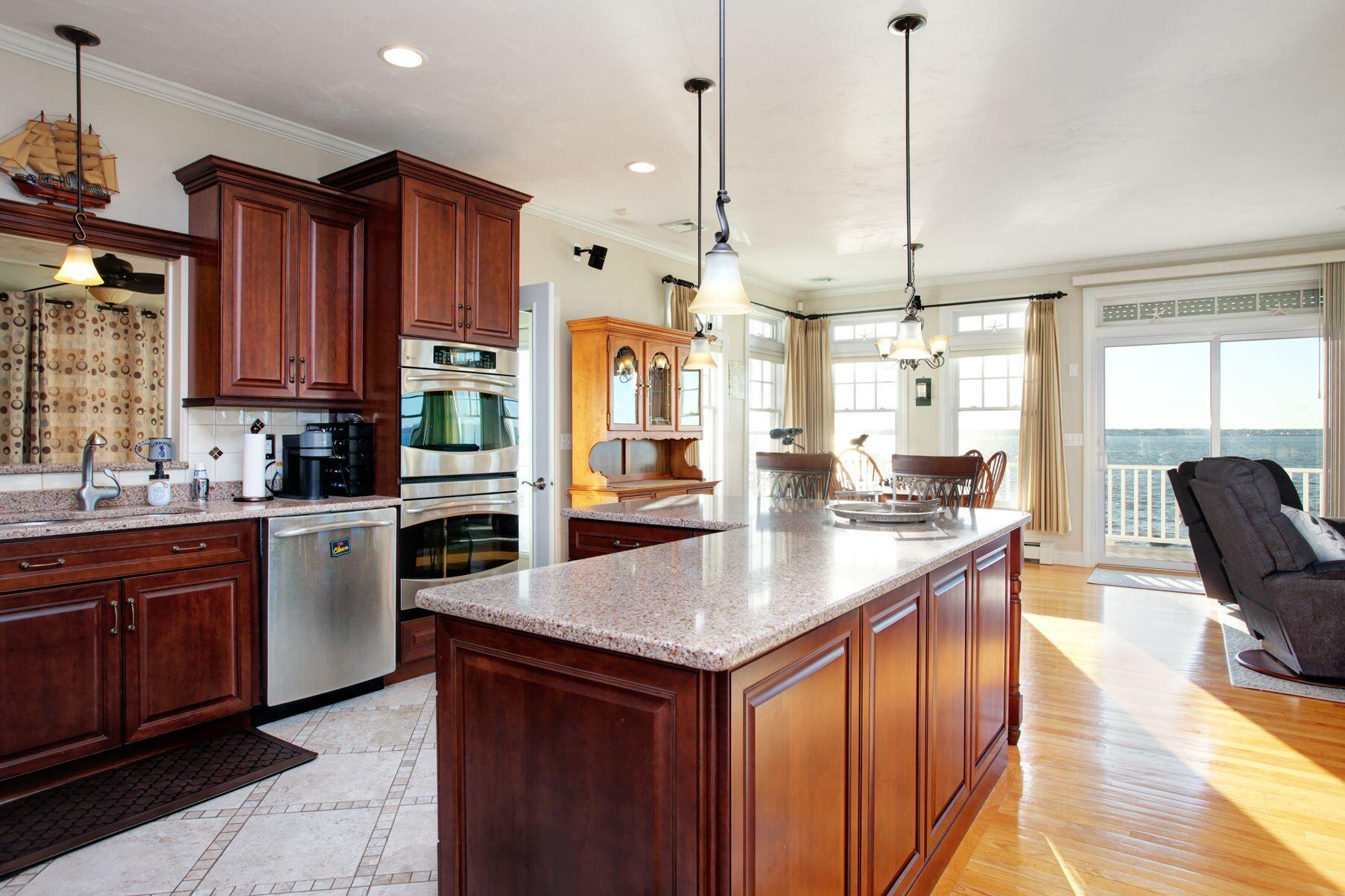 1 Calumet Road Fairhaven, MA 02719 - Photo 9 of 30 a kitchen with stainless steel appliances granite countertop a sink a stove and a wooden floors
