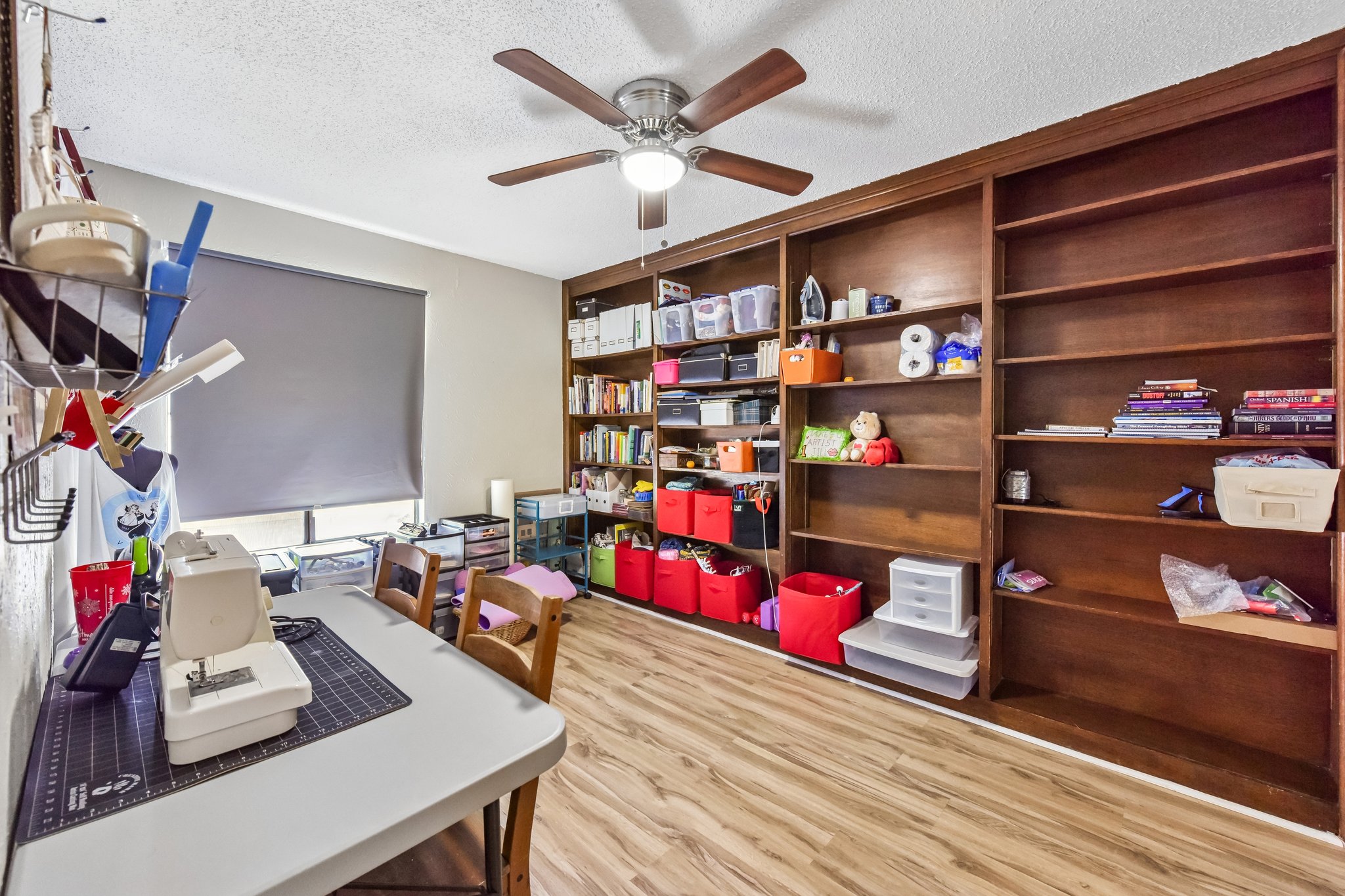 9610 Covey Ridge Lane Austin, TX 78758 - Photo 17 of 22 Built-in wood shelving units spanning the wall provide extensive storage