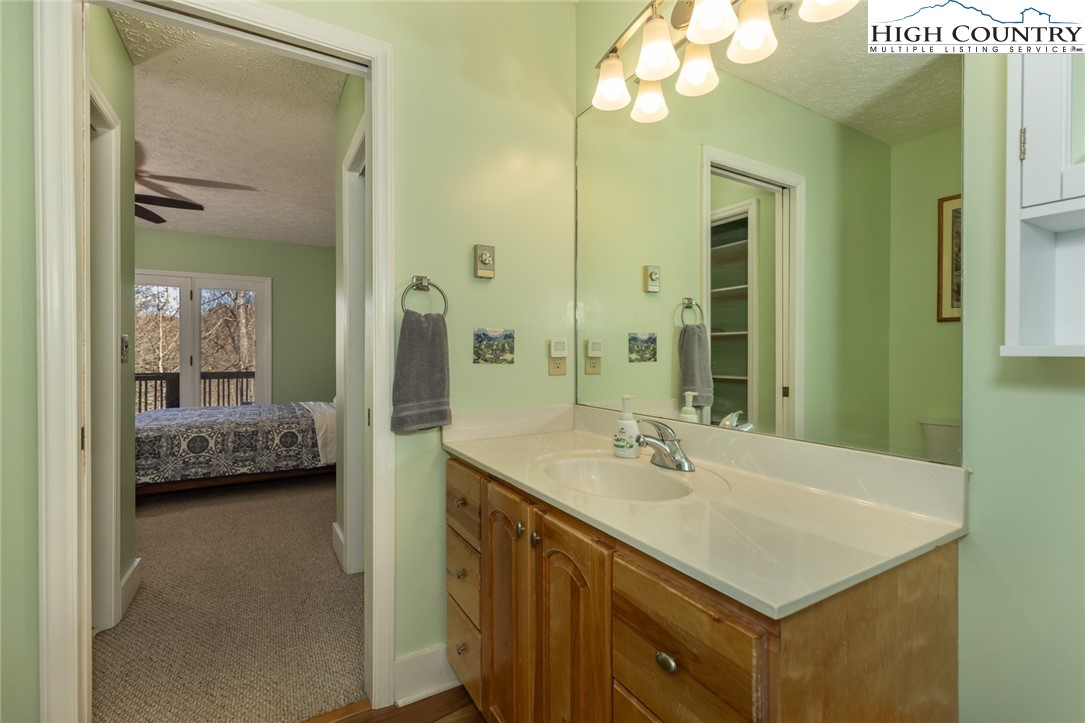 446 Peaceful Haven Drive, Unit 811 Boone, NC 28607 - Photo 15 of 19 a bathroom with a sink a double vanity and a mirror