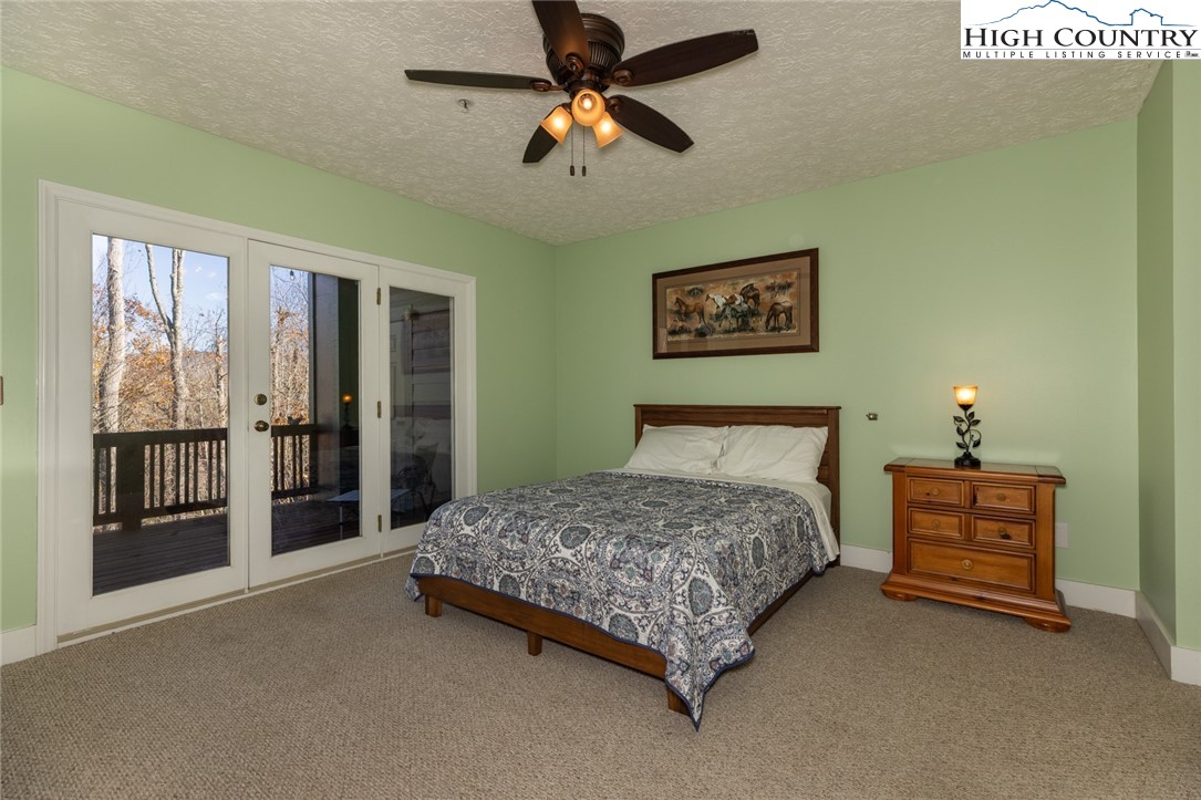 446 Peaceful Haven Drive, Unit 811 Boone, NC 28607 - Photo 18 of 19 a bedroom with a bed dresser and a window