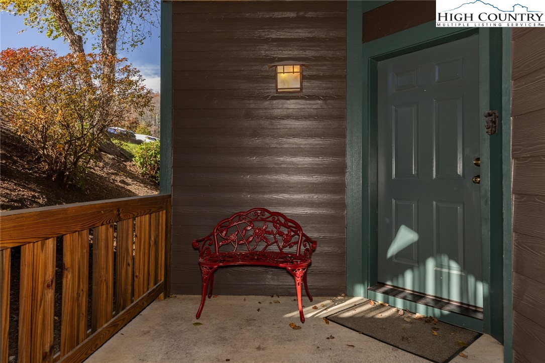 446 Peaceful Haven Drive, Unit 811 Boone, NC 28607 - Photo 6 of 19 a view of a balcony with chair and table