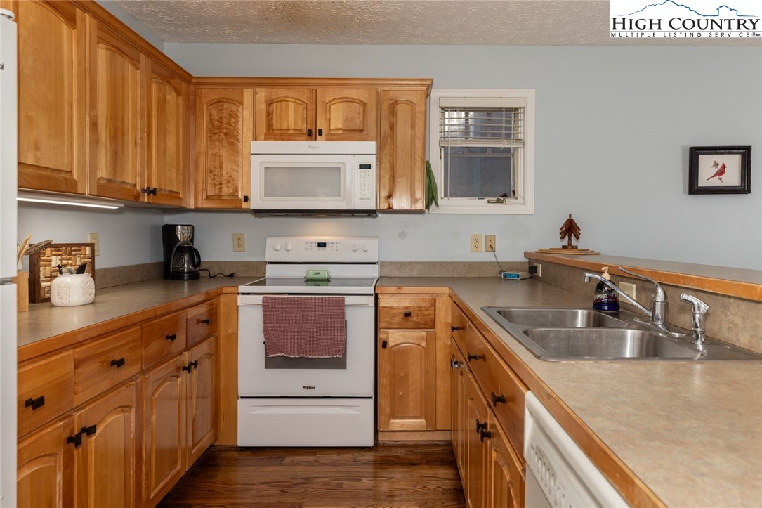 446 Peaceful Haven Drive, Unit 811 Boone, NC 28607 - Photo 8 of 19 a kitchen with stainless steel appliances granite countertop a sink stove and cabinets
