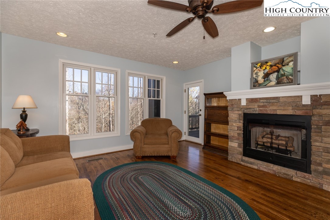 446 Peaceful Haven Drive, Unit 811 Boone, NC 28607 - Photo 9 of 19 a living room with furniture and a fireplace