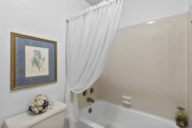a bathroom with a bathtub a sink and a shower curtain