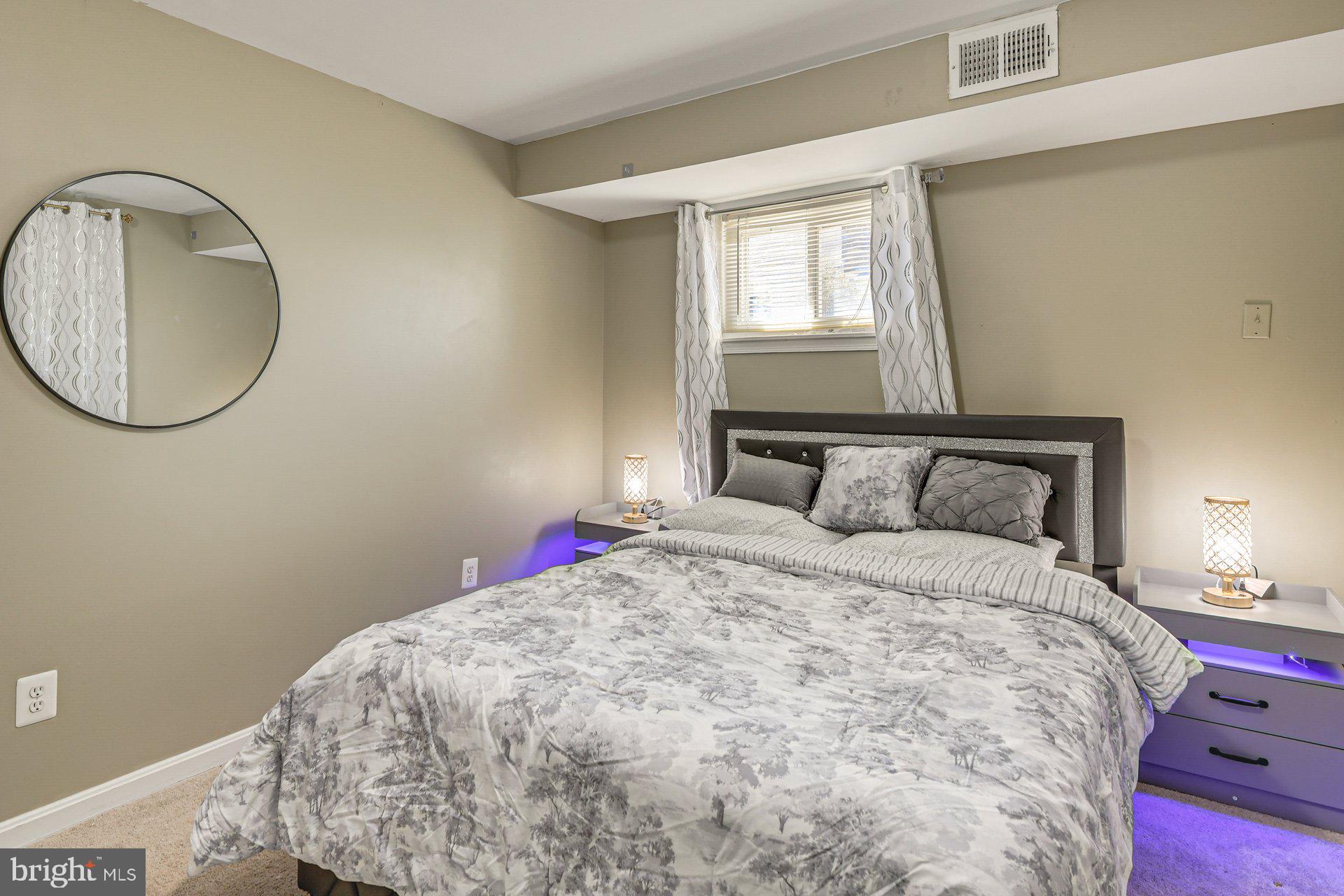 5929 Camberly Avenue Springfield, VA 22150 - Photo 13 of 24 a bedroom with a bed and a mirror