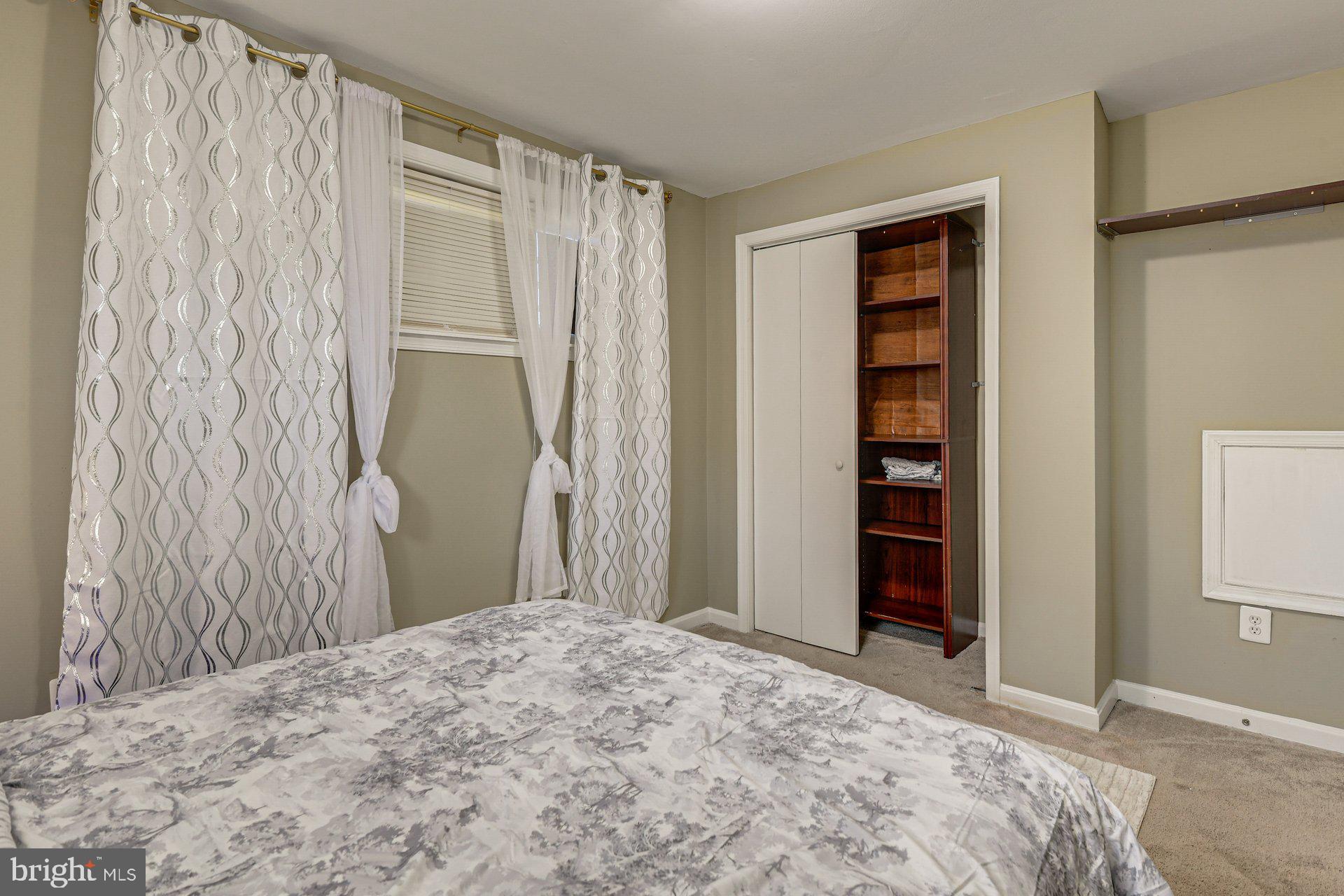 5929 Camberly Avenue Springfield, VA 22150 - Photo 14 of 24 a bedroom with a bed and a closet