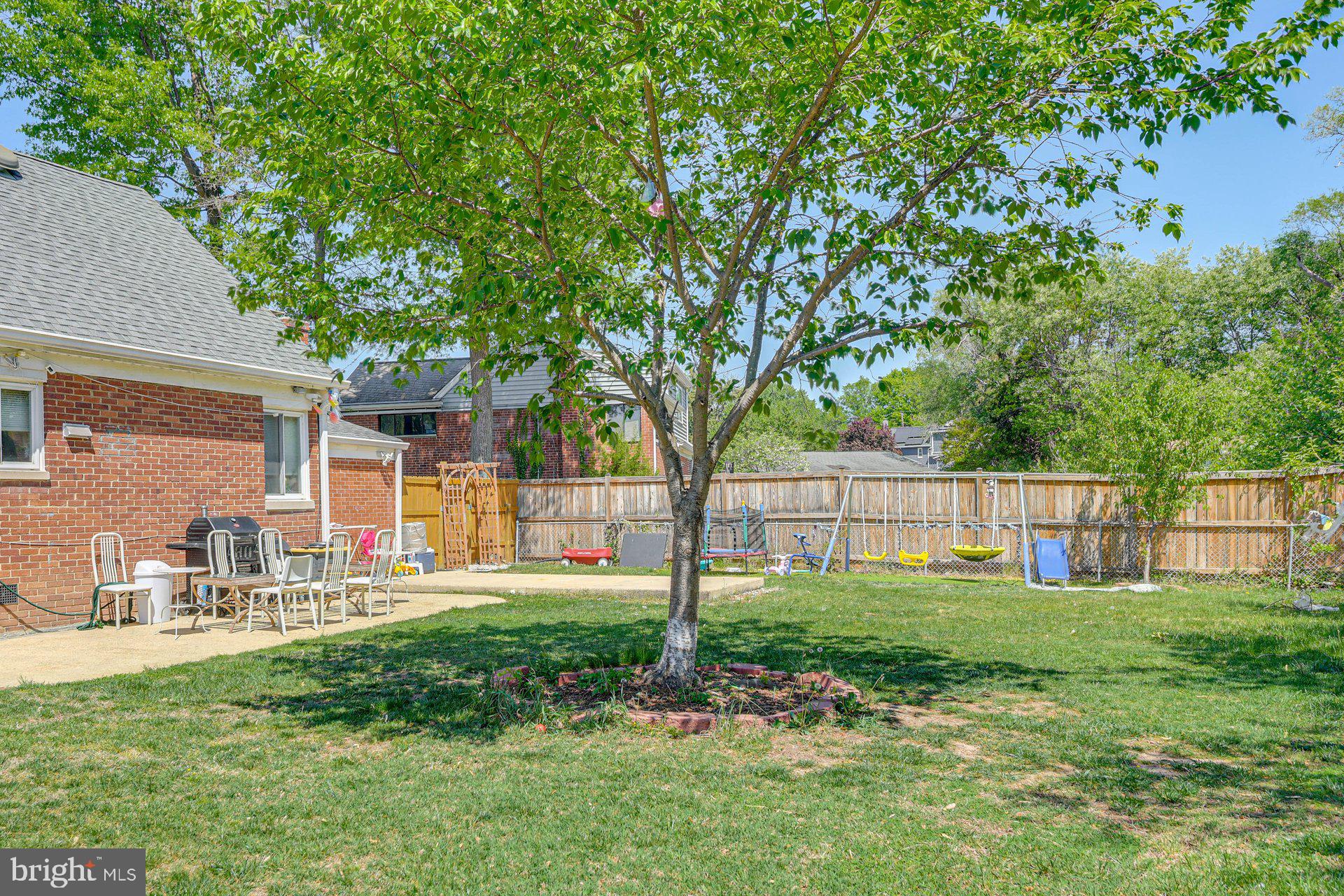 5929 Camberly Avenue Springfield, VA 22150 - Photo 21 of 24 a view of a house with a yard and sitting area
