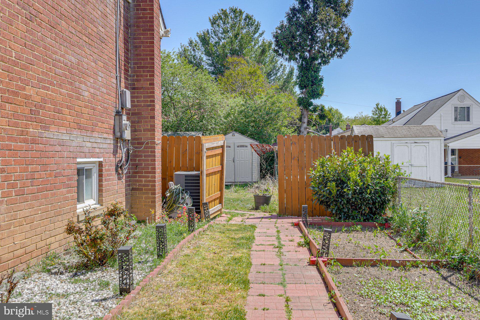 5929 Camberly Avenue Springfield, VA 22150 - Photo 23 of 24 a view of a brick house with a yard
