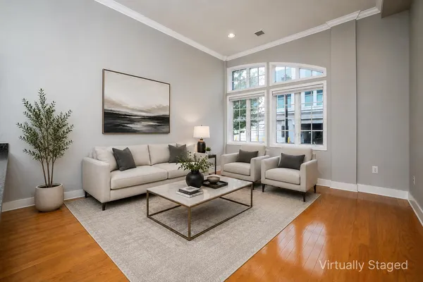 a living room with furniture potted plant and a window