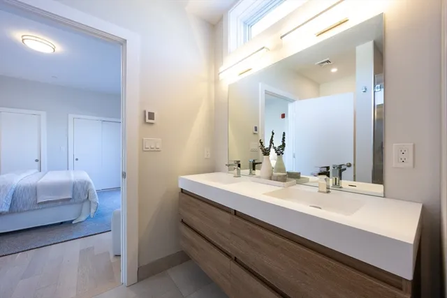 a en suite bathroom with a sink double vanity and mirror