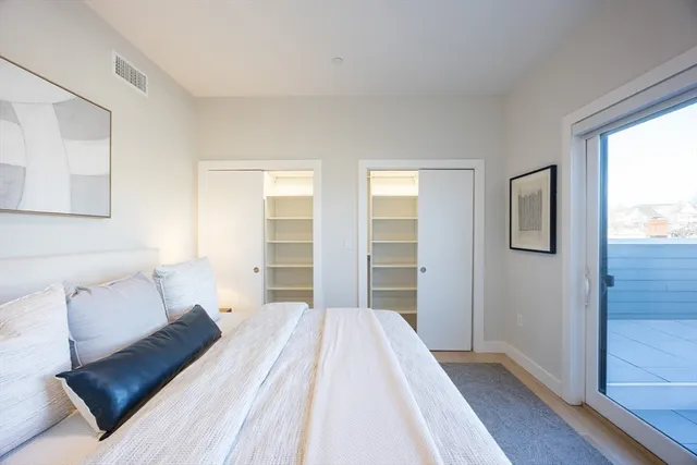 a bedroom with a bed and window