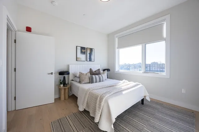 a bedroom with a bed and a window