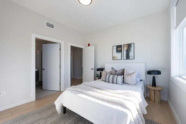 a bedroom with a bed and a painting