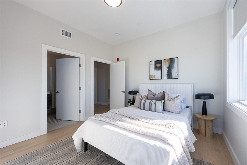 1 Loring Street, Unit 3 Somerville, MA 02143 - Photo 18 of 39 a bedroom with a bed and a painting
