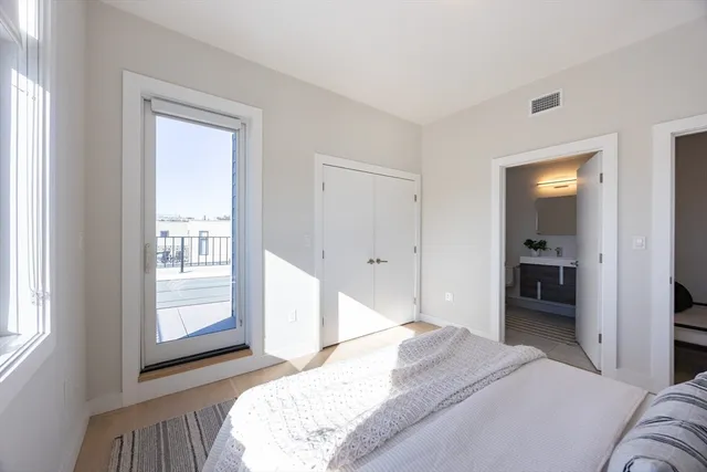 a bedroom with a bed and a large mirror