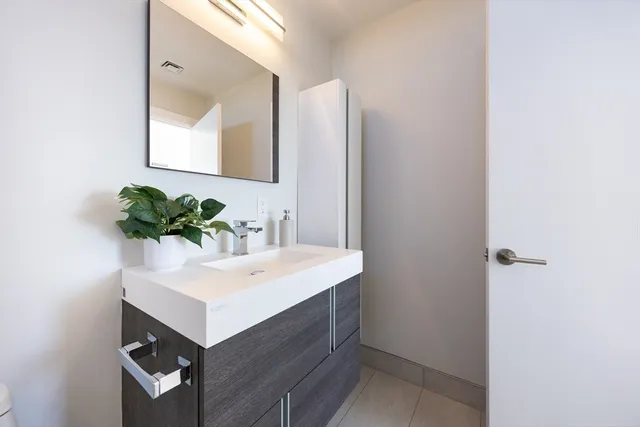a bathroom with a sink a vanity and a mirror