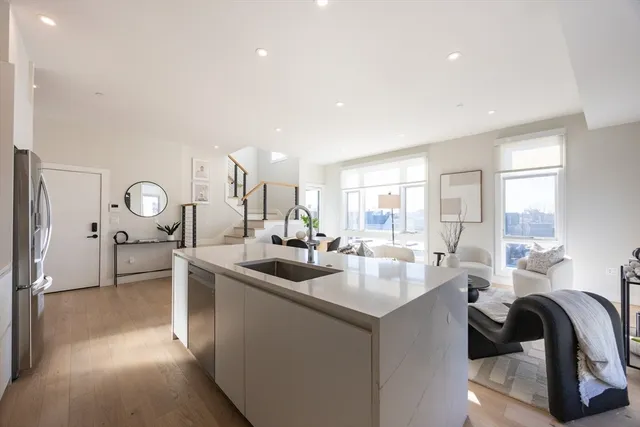 a kitchen with sink stove and cabinets