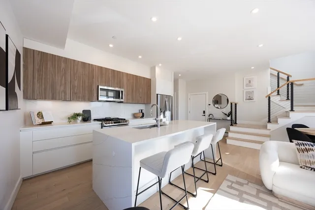 a kitchen with a sink a stove and cabinets