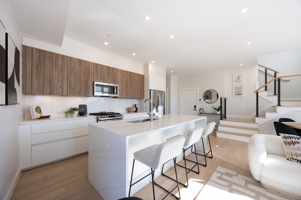 1 Loring Street, Unit 3 Somerville, MA 02143 - Photo 5 of 39 a kitchen with a sink a stove and cabinets