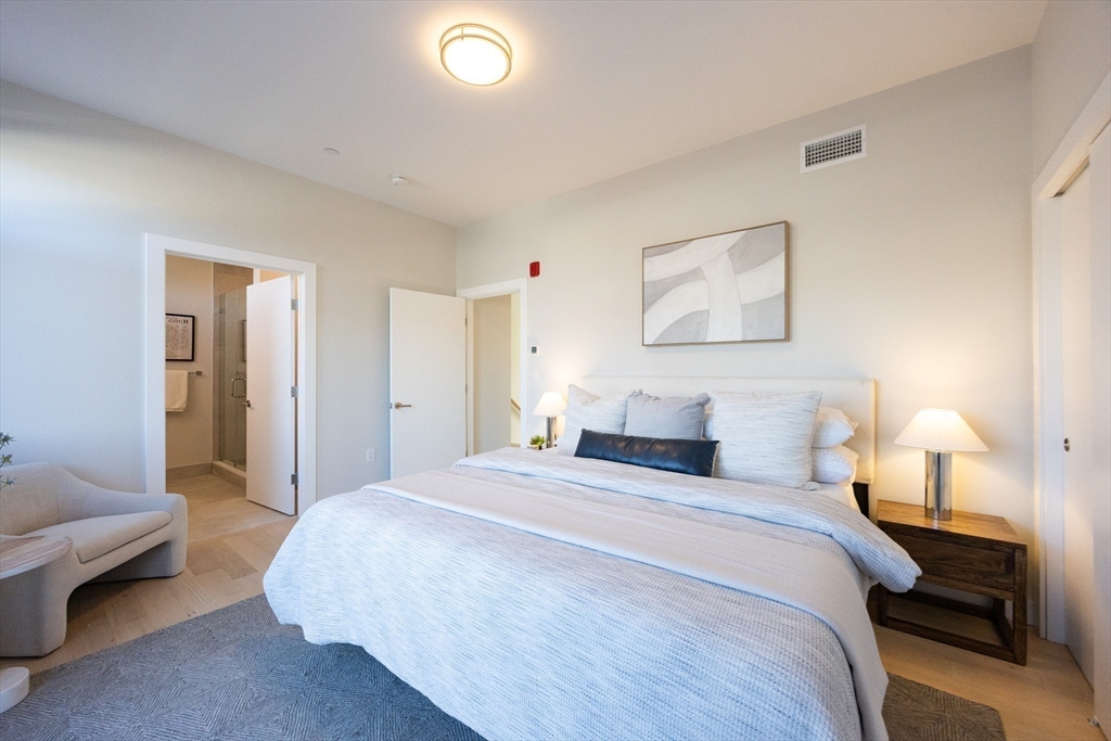 1 Loring Street, Unit 3 Somerville, MA 02143 - Photo 7 of 39 a bedroom with a bed and a couch