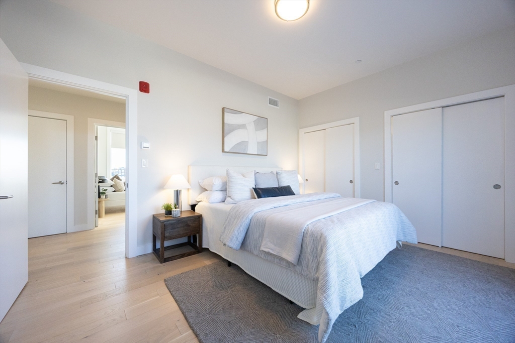 1 Loring Street, Unit 3 Somerville, MA 02143 - Photo 9 of 39 a spacious bedroom with a bed and a couch