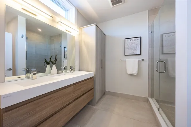 a bathroom with a double vanity sink mirror and double