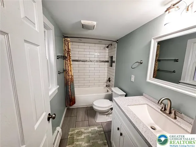 an empty room with a chandelier fan and a window