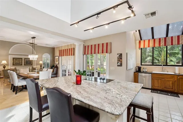 a kitchen with stainless steel appliances granite countertop a sink and cabinets