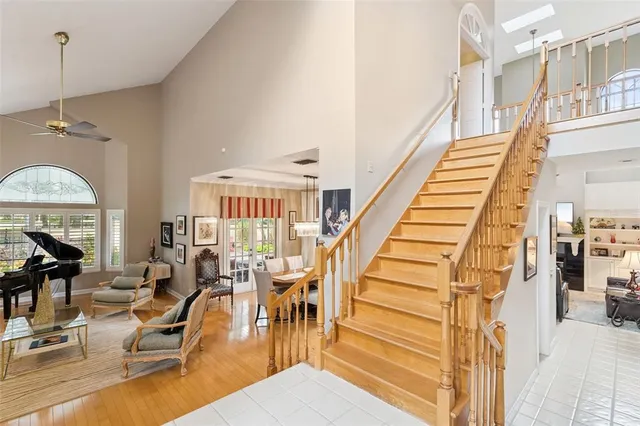 a spacious bedroom with a large bed and a chandelier