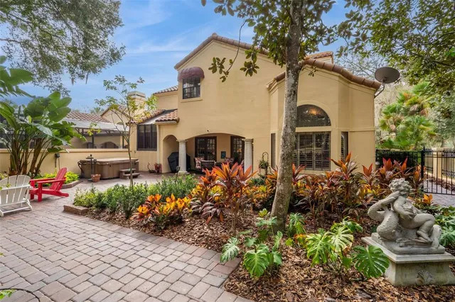 a view of a chair and table in backyard of the house