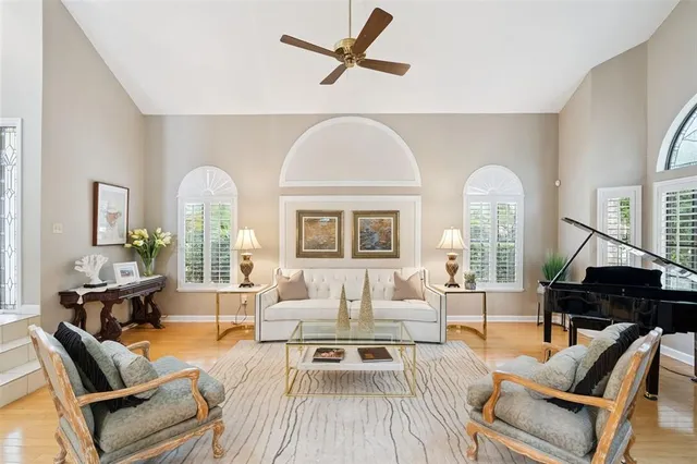 a living room with furniture a fireplace and a chandelier