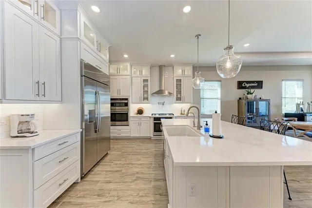 a kitchen with stainless steel appliances granite countertop a stove and a microwave