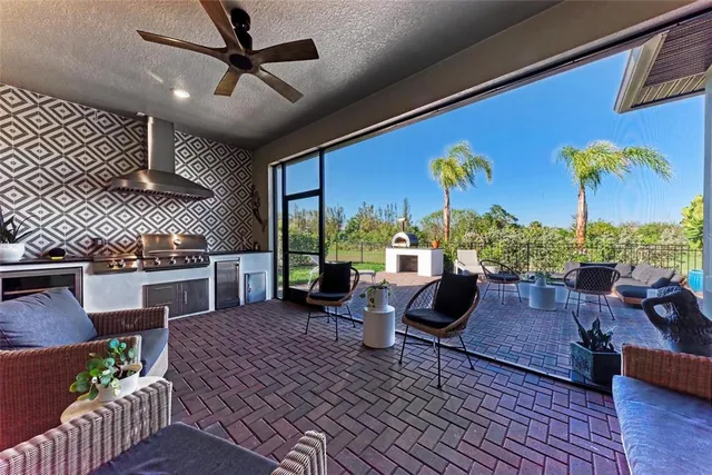 an aerial view of a resort with swimming pool tennis courts and ocean view