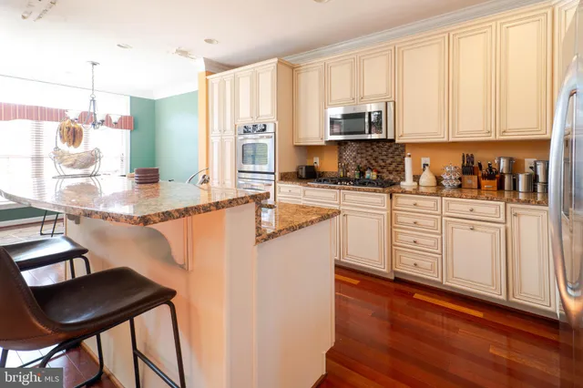 a view of staircase with lots of frames on wall and a window