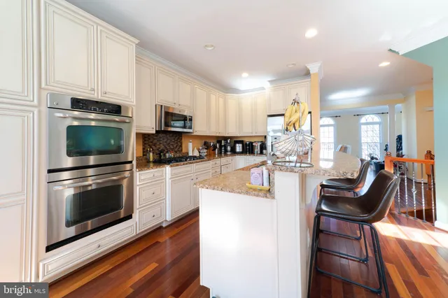a bed sitting in a spacious bedroom next to a window