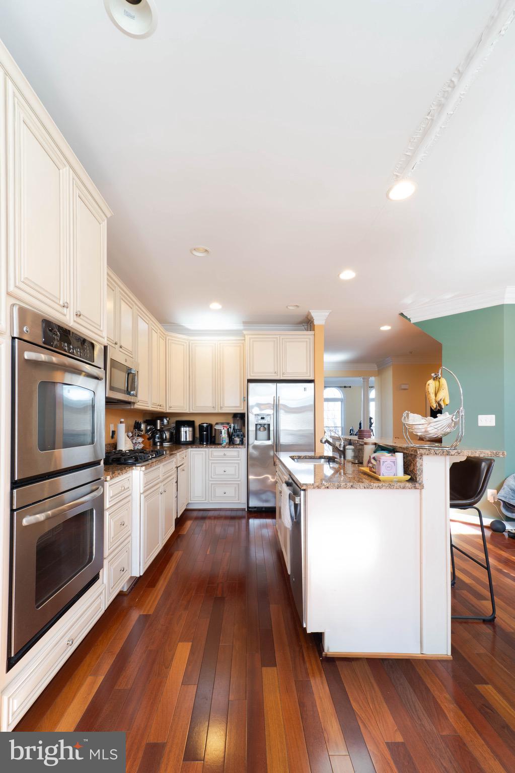 11453 Galliec Street, Unit 40 Fairfax, VA 22030 - Photo 17 of 45 a kitchen with a sink a counter top space stainless steel appliances and cabinets