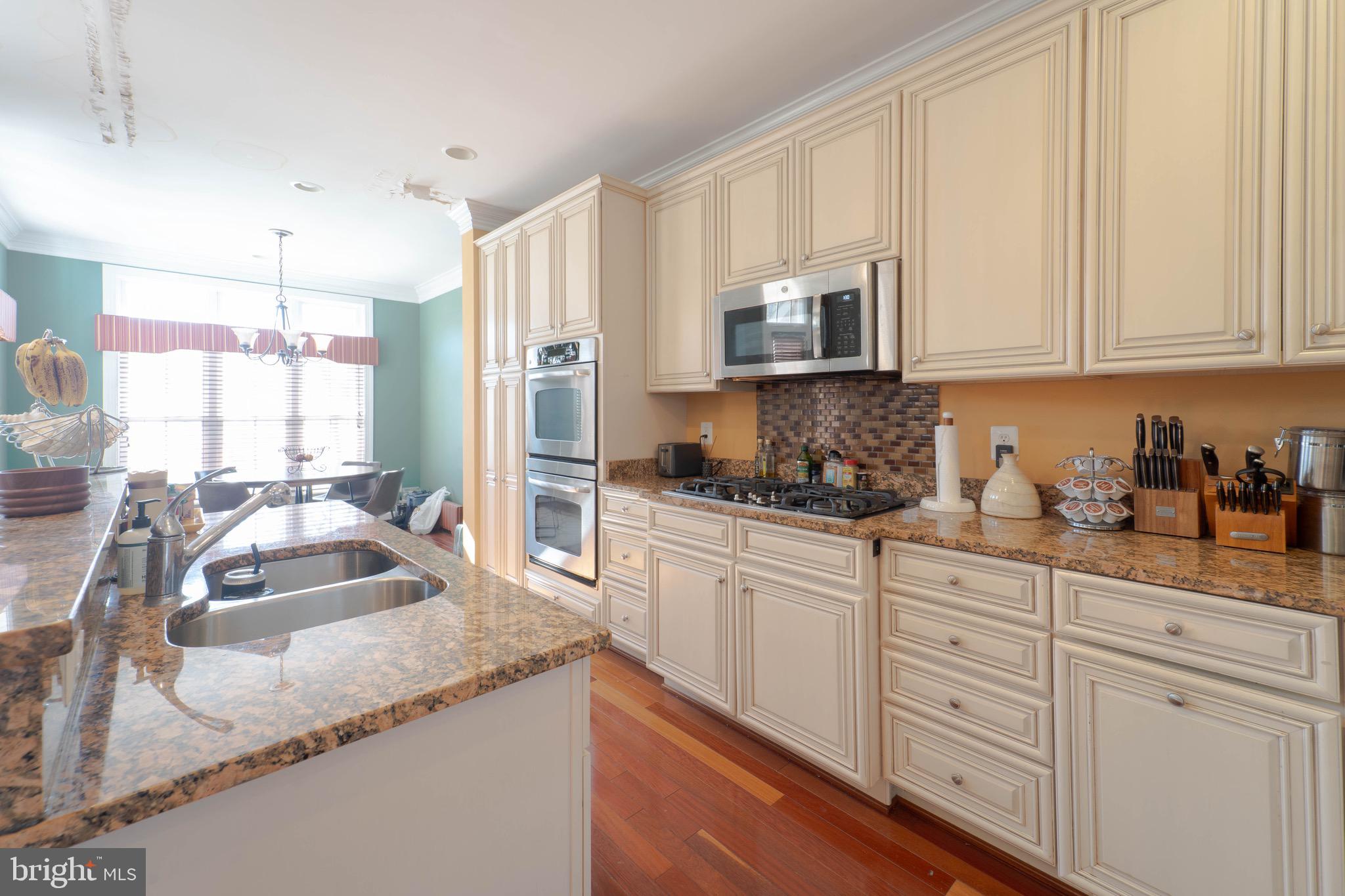 11453 Galliec Street, Unit 40 Fairfax, VA 22030 - Photo 19 of 45 a kitchen with granite countertop a sink a counter top space cabinets and stainless steel appliances