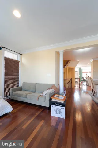a view of a room with wooden floor and fan