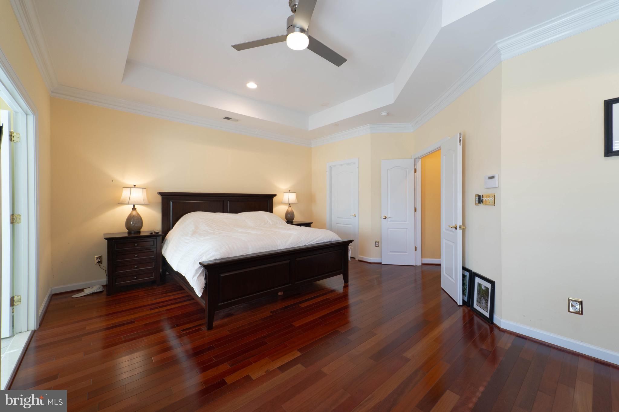 11453 Galliec Street, Unit 40 Fairfax, VA 22030 - Photo 31 of 45 a spacious bedroom with a bed and wooden floor