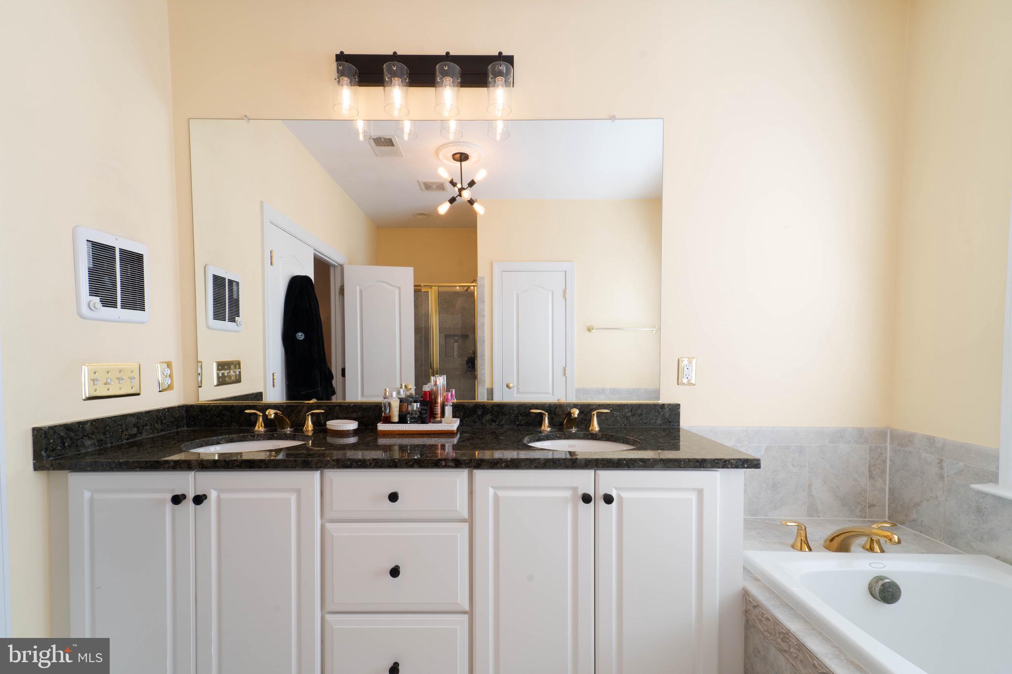 11453 Galliec Street, Unit 40 Fairfax, VA 22030 - Photo 36 of 45 a bathroom with a double vanity sink and mirror